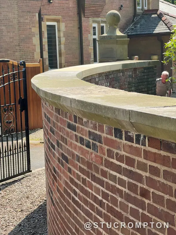 Curved wall under a stone coping