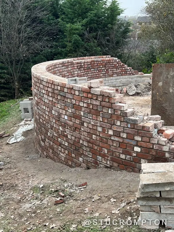 A curved wall in reclaimed brick